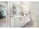 Modern bathroom with white cabinetry, double sinks, and great lighting at 450 Rockfern Ct, Lilburn, GA 30047
