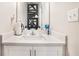 Modern powder room features stylish decor, a white vanity, and great lighting at 450 Rockfern Ct, Lilburn, GA 30047