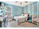 Charming bedroom with a light blue wall, cute decor, and a ceiling fan at 450 Rockfern Ct, Lilburn, GA 30047