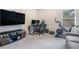 Carpeted bonus room with a TV, desk, chair, and a bike for exercising at 450 Rockfern Ct, Lilburn, GA 30047