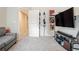 Carpeted bonus room has a TV, couch, and closet for storage at 450 Rockfern Ct, Lilburn, GA 30047