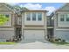 Charming townhome with a two-car garage, neutral siding, and well-maintained landscaping at 450 Rockfern Ct, Lilburn, GA 30047