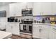 Kitchen with stainless steel appliances, white subway tile backsplash, and quartz countertops at 450 Rockfern Ct, Lilburn, GA 30047