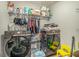A laundry room area with a washer and dryer, shelves, and other items at 450 Rockfern Ct, Lilburn, GA 30047