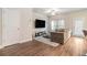 Living room with wood floors, a large TV, and lots of natural light at 450 Rockfern Ct, Lilburn, GA 30047