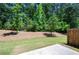 A beautiful backyard features a well manicured lawn and mulch bed. Tall trees provide plenty of shade at 213 Yellowwood Way, Woodstock, GA 30188