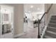 Interior entryway featuring staircase, half bath, and view to the kitchen at 213 Yellowwood Way, Woodstock, GA 30188