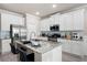 Eat in kitchen showcasing granite countertops, stainless steel appliances, and ample white cabinetry at 213 Yellowwood Way, Woodstock, GA 30188