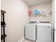 Laundry room with washer, dryer, and wire shelf at 213 Yellowwood Way, Woodstock, GA 30188