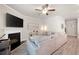Spacious living room offering ceiling fan, laminate flooring, fireplace, and comfortable furnishings at 213 Yellowwood Way, Woodstock, GA 30188