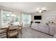 Inviting living room featuring gray laminate flooring, fireplace, and large windows for natural light at 213 Yellowwood Way, Woodstock, GA 30188