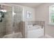 Luxurious bathroom with glass-enclosed shower and soaking tub at 213 Yellowwood Way, Woodstock, GA 30188