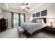 Spacious main bedroom featuring neutral walls, tray ceiling, ceiling fan, and plush carpeting at 213 Yellowwood Way, Woodstock, GA 30188