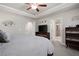 Main bedroom with ceiling fan, television, and bathroom with glass shower door at 213 Yellowwood Way, Woodstock, GA 30188