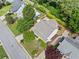 Aerial view of a landscaped property featuring a well-maintained home with a lush green lawn and trees at 3405 Haverhill Rowe, Lawrenceville, GA 30044