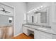 Bathroom features double sinks, granite countertop, and wood flooring with access to adjacent bedroom at 3405 Haverhill Rowe, Lawrenceville, GA 30044