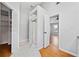 Bright bathroom featuring tiled floors, shower with glass door, and open view to adjacent bedroom at 3405 Haverhill Rowe, Lawrenceville, GA 30044