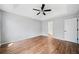 Bedroom features hardwood floors, a ceiling fan, and a doorway leading to the bathroom at 3405 Haverhill Rowe, Lawrenceville, GA 30044