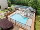 Aerial view of the community pool and tennis court with lounge chairs and lush greenery surrounding the area at 3405 Haverhill Rowe, Lawrenceville, GA 30044