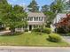 Charming two-story home featuring a well-manicured lawn, mature trees and classic black shutters at 3405 Haverhill Rowe, Lawrenceville, GA 30044