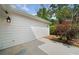 Side view of home with concrete patio area adjacent to mature landscaping at 3405 Haverhill Rowe, Lawrenceville, GA 30044