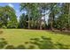 Expansive backyard with lush green grass and mature trees offering ample space and privacy at 3617 Carson Se Ln, Smyrna, GA 30080