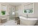 Bright bathroom featuring a soaking tub and a glass shower next to the window at 3617 Carson Se Ln, Smyrna, GA 30080