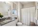Bright bathroom featuring a shower with curtain and white cabinets at 3617 Carson Se Ln, Smyrna, GA 30080