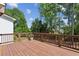 Spacious wooden deck with brown railing and greenery in the background for outdoor enjoyment at 3617 Carson Se Ln, Smyrna, GA 30080