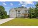 Beautiful two-story modern farmhouse with white siding, charming front porch, and well-manicured lawn at 3617 Carson Se Ln, Smyrna, GA 30080