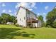 Two-story home with a well-manicured lawn, a deck, and siding, surrounded by mature trees at 3617 Carson Se Ln, Smyrna, GA 30080