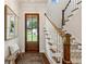 Warm foyer with wooden door, bench, and stairs with carpet runner leading to the upper level at 3617 Carson Se Ln, Smyrna, GA 30080