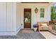 Inviting front porch featuring brick flooring, wooden bench, and a charming wooden front door at 3617 Carson Se Ln, Smyrna, GA 30080