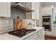Modern kitchen featuring stainless steel appliances, including a double oven and sleek range hood over the gas cooktop at 3617 Carson Se Ln, Smyrna, GA 30080