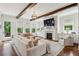 Cozy living room with a fireplace, built-in shelves, and an L-shaped sofa with an open view to the deck at 3617 Carson Se Ln, Smyrna, GA 30080