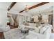 Elegant open-concept living space featuring hardwood floors, a white L-shaped sofa, and a modern kitchen at 3617 Carson Se Ln, Smyrna, GA 30080