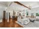 Spacious living room featuring hardwood floors, a white L-shaped sofa, and an open-concept kitchen at 3617 Carson Se Ln, Smyrna, GA 30080