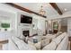 Elegant living room with fireplace, custom built-ins, hardwood floors, and exposed ceiling beams at 3617 Carson Se Ln, Smyrna, GA 30080
