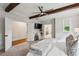 Spacious main bedroom with exposed beams, a ceiling fan, and an open layout leading to the ensuite bathroom and closet at 3617 Carson Se Ln, Smyrna, GA 30080