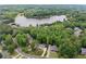 Stunning aerial view of a home nestled amongst trees and the community lake at 641 Lake Overlook Dr, Canton, GA 30114
