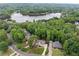 Aerial view of the property showcasing the house, surrounding trees, and a beautiful lake at 641 Lake Overlook Dr, Canton, GA 30114