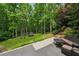 Lush backyard with trampoline, mature trees, stone steps, and a cozy patio seating area at 641 Lake Overlook Dr, Canton, GA 30114