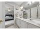 Bathroom with double sinks, white cabinetry, and adjacent bedroom creating a functional and stylish space at 641 Lake Overlook Dr, Canton, GA 30114