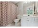 Charming bathroom with decorative shower curtain, white vanity, and well-lit space at 641 Lake Overlook Dr, Canton, GA 30114