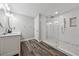 Modern bathroom features an oversized glass walk-in shower, double vanity, and stylish tile at 641 Lake Overlook Dr, Canton, GA 30114