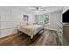 Comfortable bedroom with natural light, hardwood floors, ceiling fan, and a decorative wall at 641 Lake Overlook Dr, Canton, GA 30114
