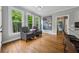 Breakfast nook featuring large windows with picturesque views, hardwood floors, and a floral painting at 641 Lake Overlook Dr, Canton, GA 30114