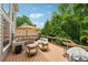 Spacious wooden deck with comfortable seating area, umbrella, and view of lush trees at 641 Lake Overlook Dr, Canton, GA 30114