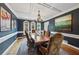 Stylish dining room with elegant lighting, wainscoting and a large picture window at 641 Lake Overlook Dr, Canton, GA 30114
