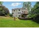 Rear exterior of the home showcasing a deck, landscaped yard, and multi-level patio at 641 Lake Overlook Dr, Canton, GA 30114